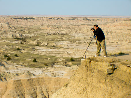 Berty takes a picture standing close to a cliff